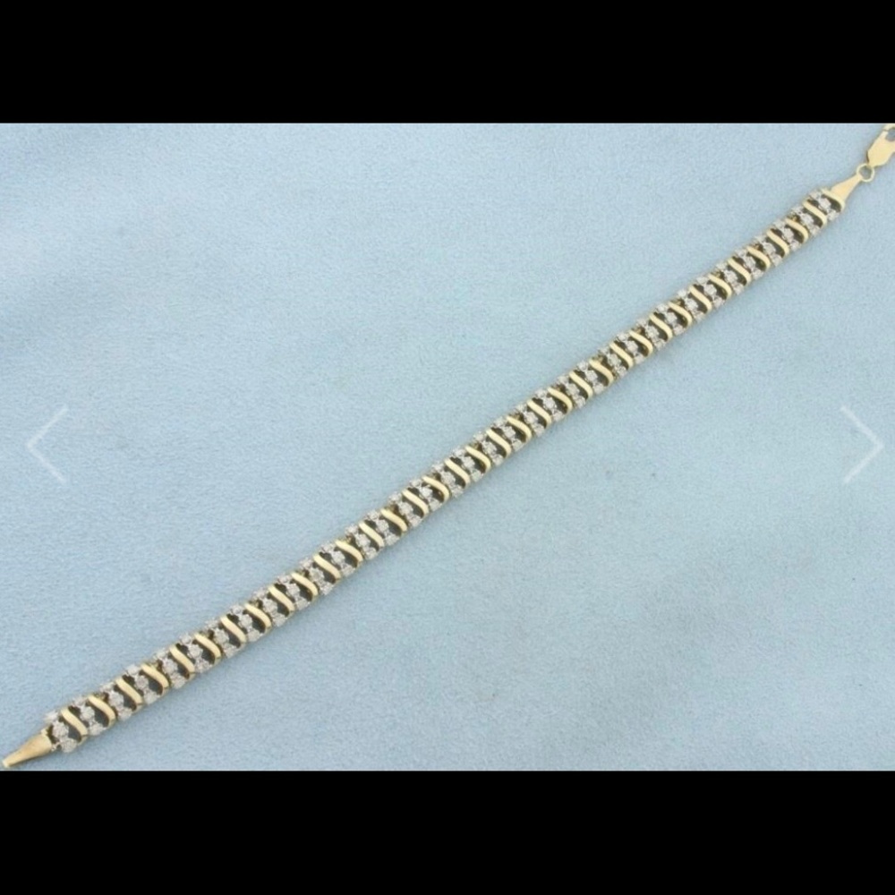 10k-1ct. TW of diamonds, I color/I clarity. 6.5mm wide. Lobster clasp. 8.7g.